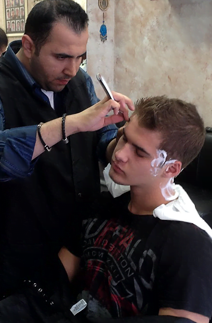 Barber cutting teenagers hair